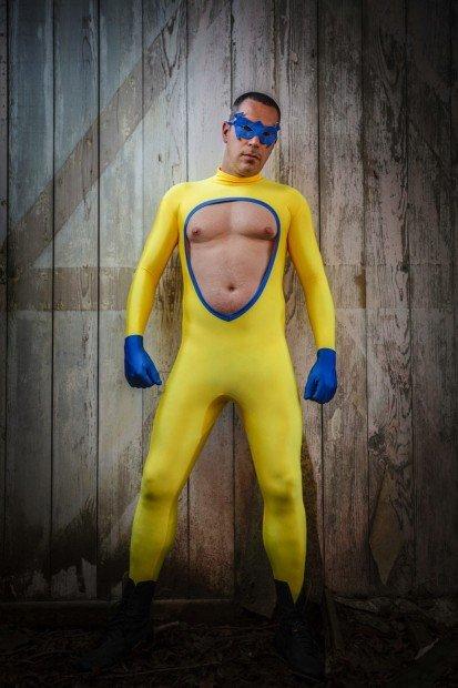 Man wearing a fetish yellow super hero outfit. Vertical shot Potbox.it
