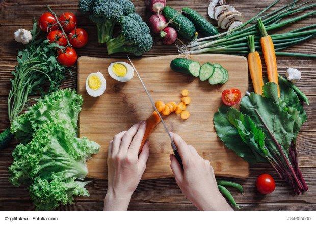 Healthy food and ingredients with tomato, salad, arugula, carrots, beet, beetroot, leaves, cucumber, onion, green, radish, mushrooms, garlic, broccoli, half, egg and peas on rustic wooden background, top view 