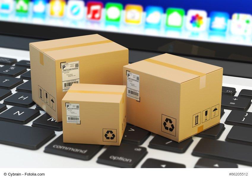 Internet shopping, online purchase, e-commerce and packages delivery concept, merchandise cardboard boxes on laptop keyboard