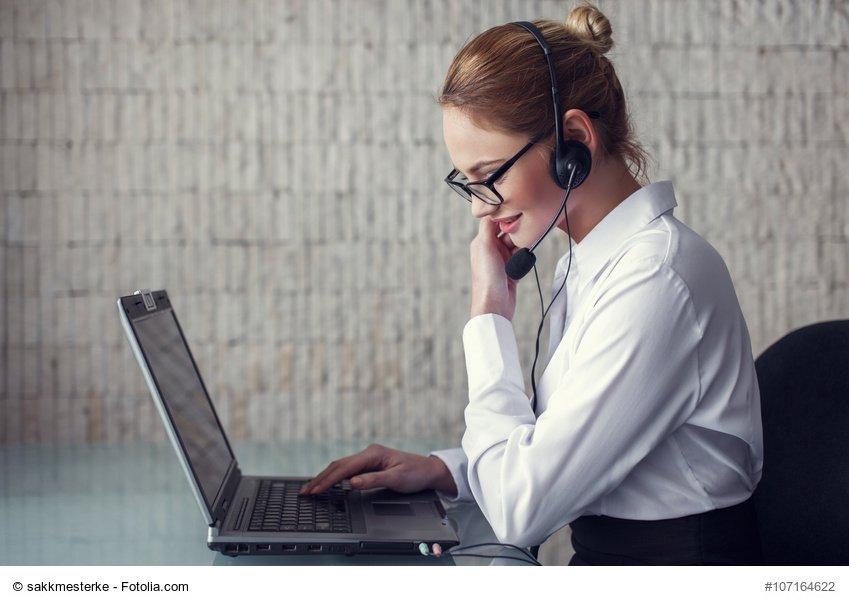 Female customer support emloyee talking online in office