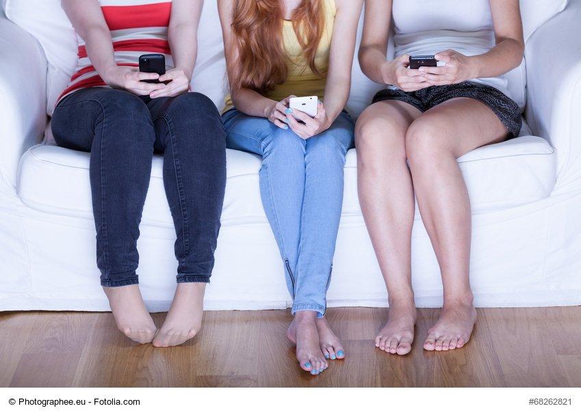 Girls using phones on meeting