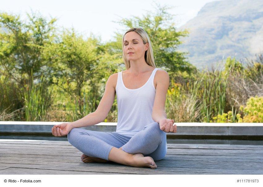 Woman meditating outdoors