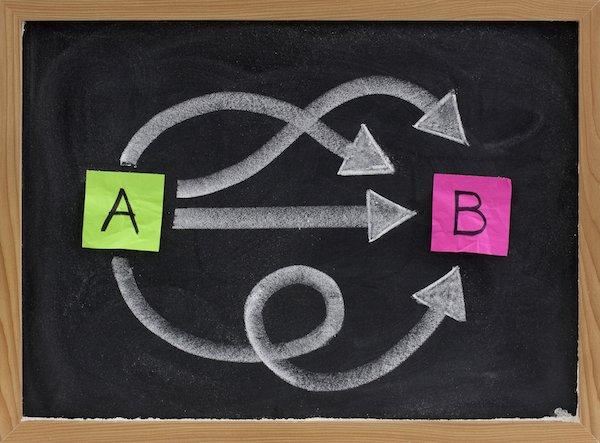 Multiple ways for going from A to B, reaching destination or solution, alternatives - concept presented with sticky notes, white chalk on blackboard